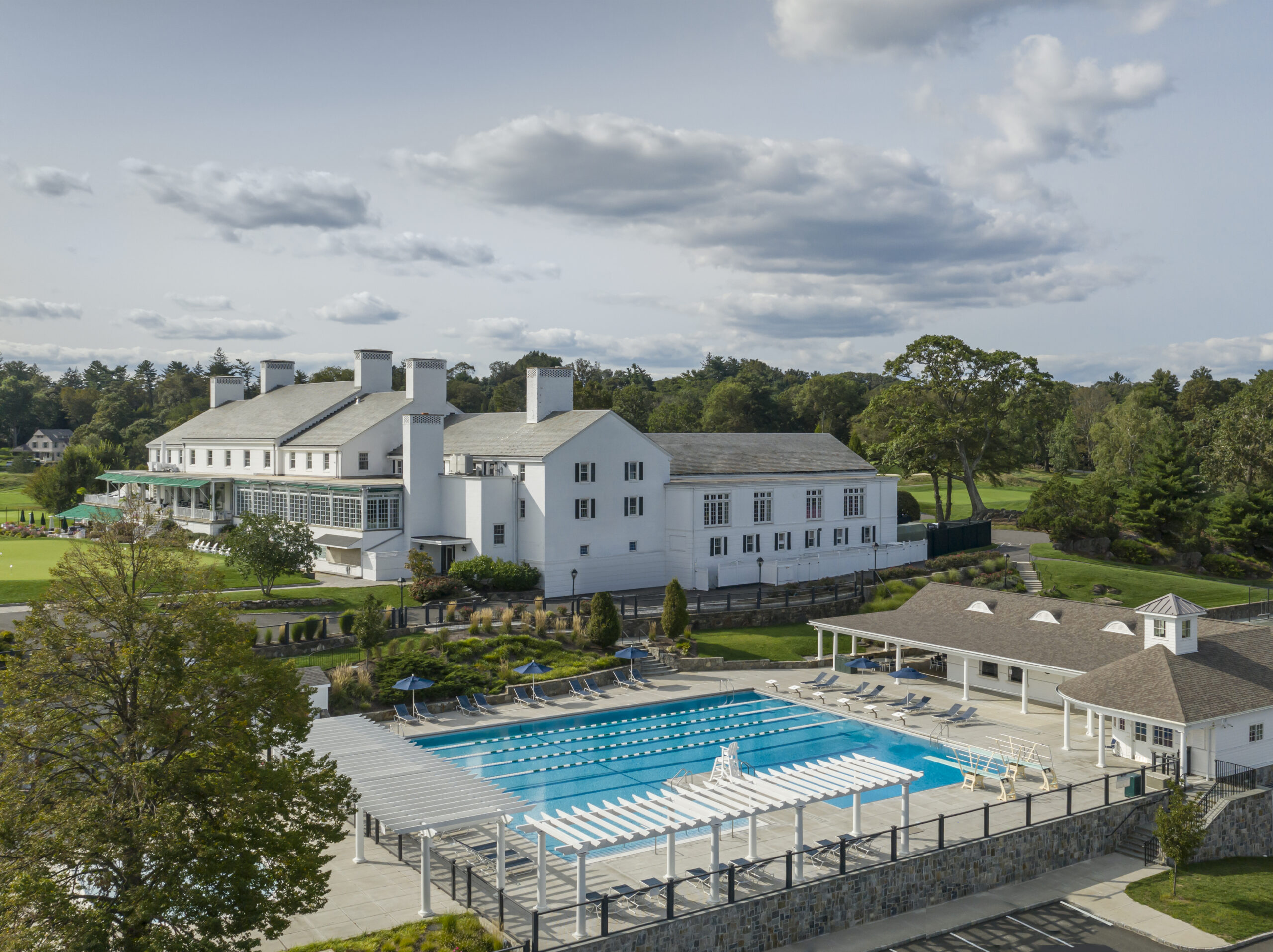 large landscape image of the pool deck along with the main building