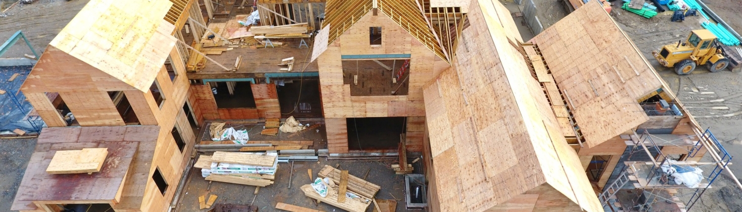 House under construction showing partially competed roof with some of its framing visible