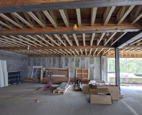 Inside of a building under construction, supporting columns and framing visible