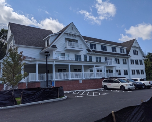 Apartment building pictured from the side parking lot