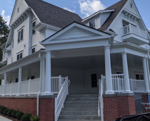 Staircase leading up to the covered porch of the apartment