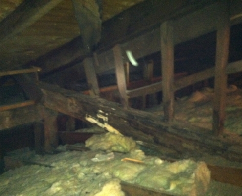 Old roof structure showing damage to the framing