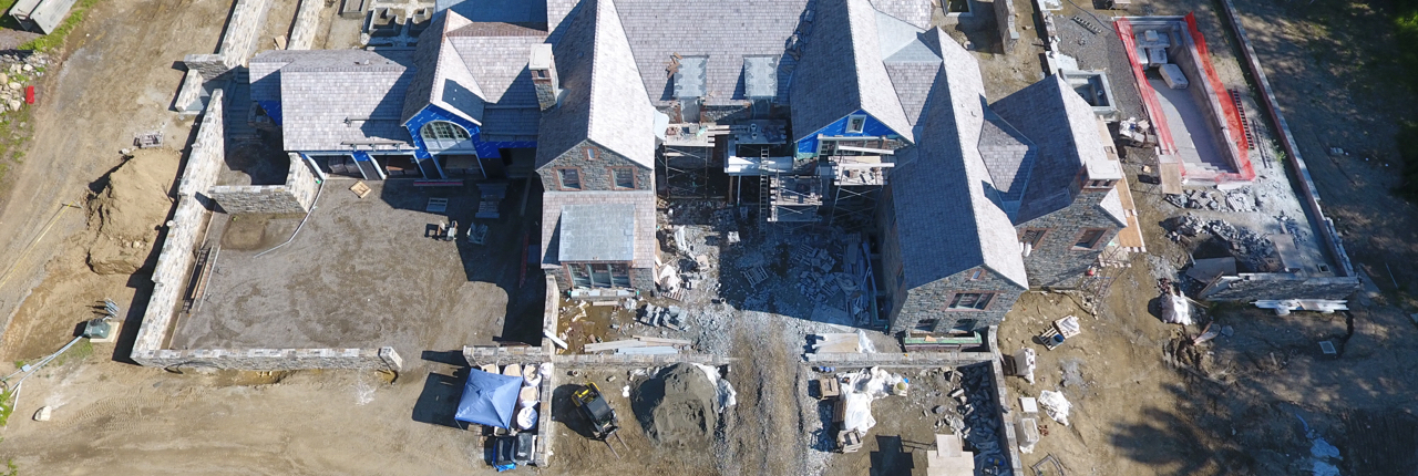 Drone image from above the house showing its roof while construction is still going on around