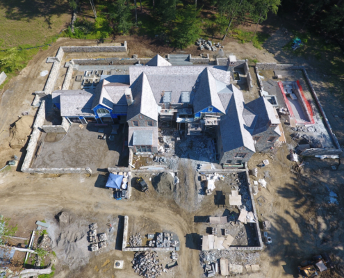 Drone image from above the house showing its roof while construction is still going on around