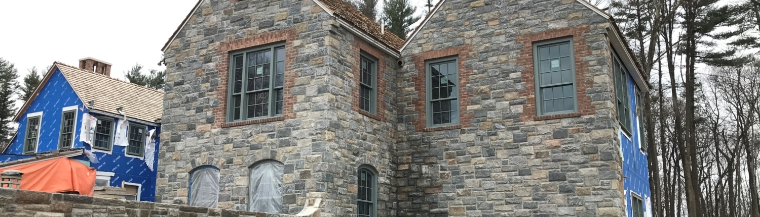 Side angle of house showing the stone works and windowns