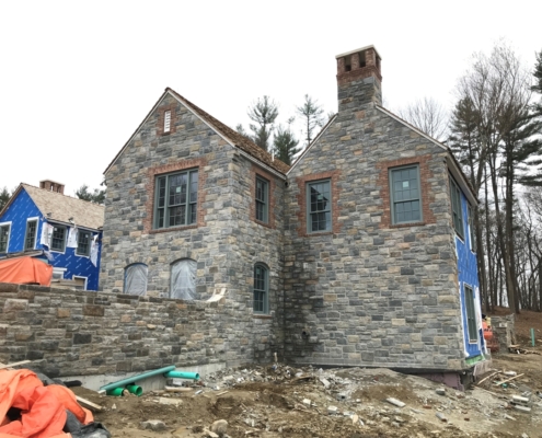Side angle of house showing the stone works and windowns