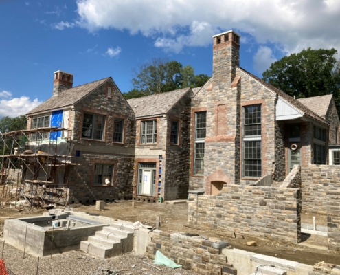 Rear of house with stone steps leading to raised area where house is