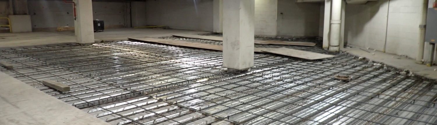 Garage floor repair showing exposed rebar support