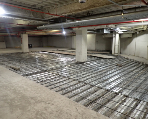 Garage floor repair showing exposed rebar support