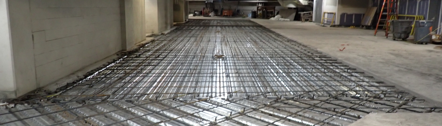 Garage floor repair showing exposed rebar support