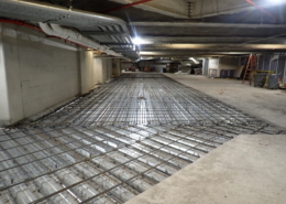 Garage floor repair showing exposed rebar support