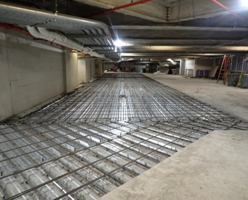 Garage floor repair showing exposed rebar support