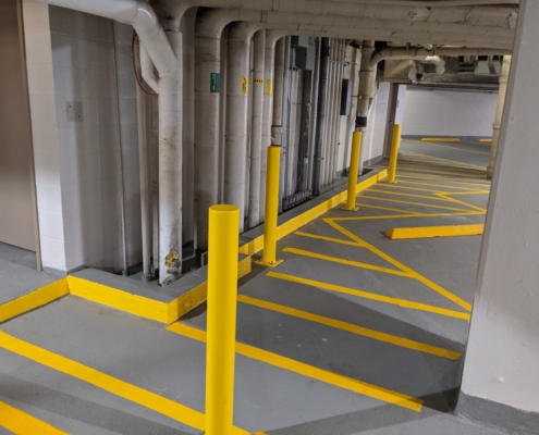 Finished repair area with new lines painted and floor patched