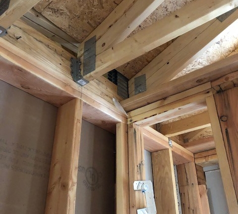 Framing of building showing joist hangars